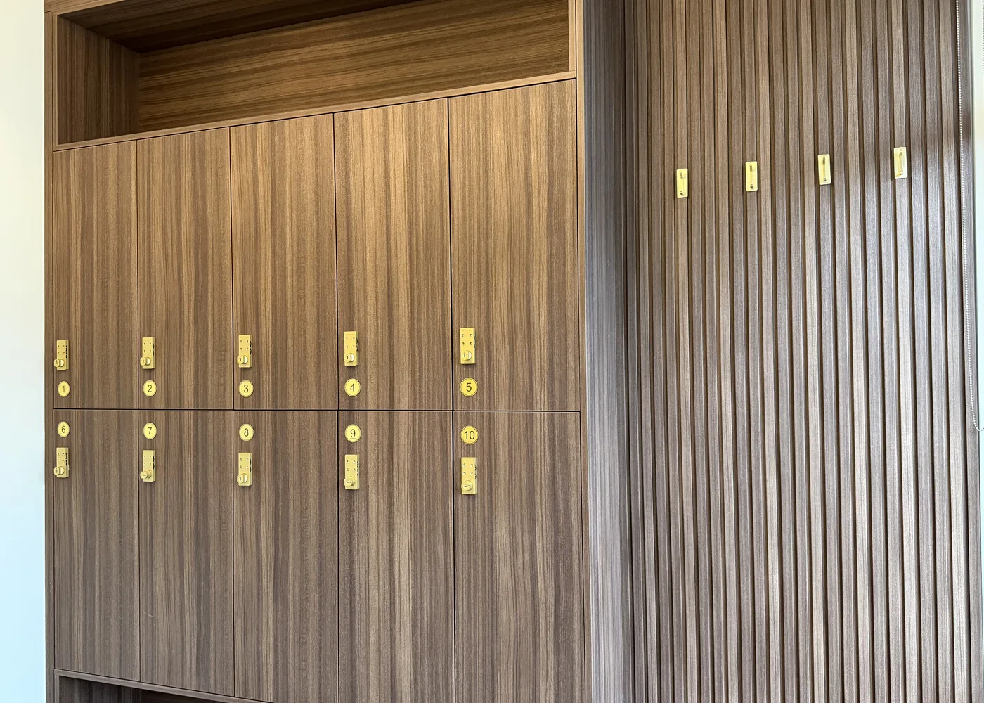 Wood lockers with numbered brass locks in the changing room